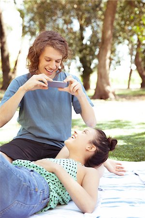 simsearch:632-07674444,k - Young man photographing girlfriend with smartphone Stock Photo - Premium Royalty-Free, Code: 633-08639012