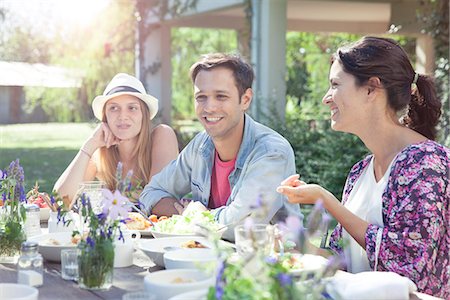 Friends chatting while enjoying healthy meal together Stock Photo - Premium Royalty-Free, Code: 633-08726158