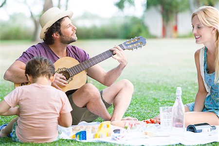 simsearch:628-07072734,k - Man playing acoustic guitar next to wife and son Stock Photo - Premium Royalty-Free, Code: 633-08726294