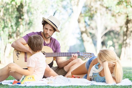 simsearch:628-07072734,k - Man playing acoustic guitar for wife and son Stock Photo - Premium Royalty-Free, Code: 633-08726296