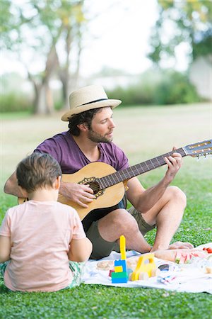 simsearch:628-07072734,k - Father playing acoustic guitar next to son Stock Photo - Premium Royalty-Free, Code: 633-08726293