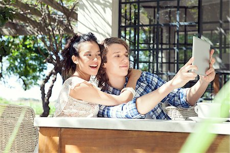 simsearch:632-07674444,k - Young couple taking selfie with digital tablet Stock Photo - Premium Royalty-Free, Code: 633-08726302