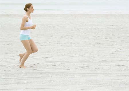 simsearch:633-01715682,k - Young woman running on beach Stock Photo - Premium Royalty-Free, Code: 633-01274223