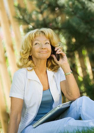 phone one person adult smile elderly - Senior woman sitting outdoors with laZSop on lap Stock Photo - Premium Royalty-Free, Code: 633-01274662