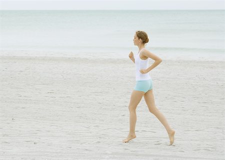 simsearch:633-01715682,k - Young woman running on beach Stock Photo - Premium Royalty-Free, Code: 633-01274706