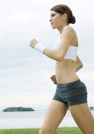 simsearch:633-01715682,k - Young woman power walking outdoors Stock Photo - Premium Royalty-Free, Code: 633-01274707