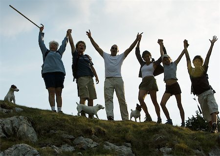 Hikers standing side by side, arms in the air Stock Photo - Premium Royalty-Free, Code: 633-01274809