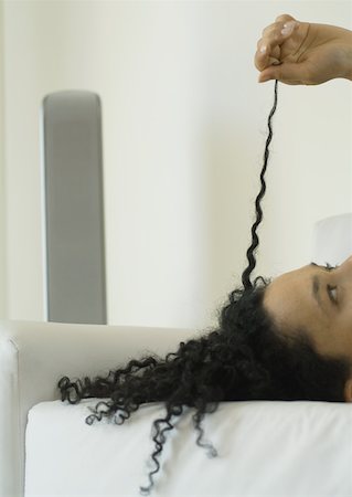 Woman pulling strand of hair Stock Photo - Premium Royalty-Free, Code: 633-01272100
