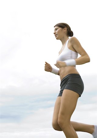 simsearch:633-01715682,k - Young woman jogging, low angle view Stock Photo - Premium Royalty-Free, Code: 633-01272214