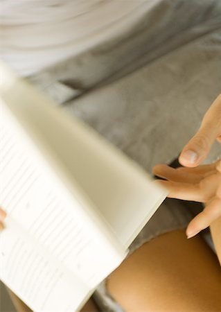 Woman turning pages of book, partial view Stock Photo - Premium Royalty-Free, Code: 633-01272263