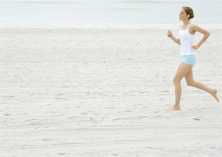 simsearch:633-01715682,k - Young woman running on beach Stock Photo - Premium Royalty-Free, Code: 633-01272390