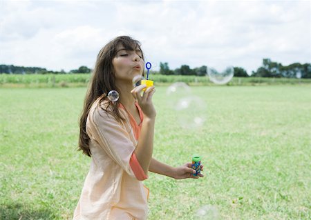 simsearch:632-05604245,k - Girl blowing bubbles Stock Photo - Premium Royalty-Free, Code: 633-01272511