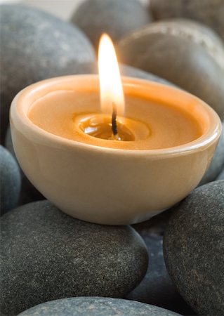 Lit candle on stones Stock Photo - Premium Royalty-Free, Code: 633-01273307