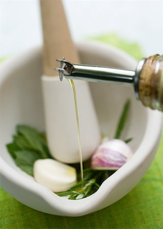 pourer - Mortar and pestle with herbs, olive oil and garlic Stock Photo - Premium Royalty-Free, Code: 633-01273862
