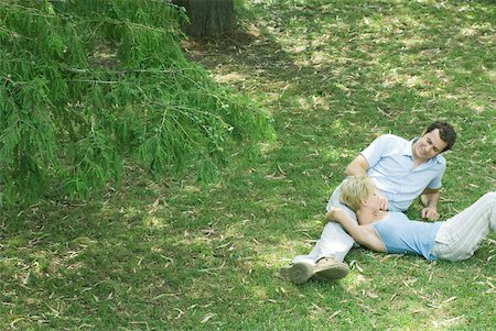 simsearch:633-01715612,k - Couple reclining on grass Stock Photo - Premium Royalty-Free, Code: 633-01574046