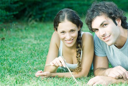 simsearch:633-01715612,k - Couple lying in grass together Stock Photo - Premium Royalty-Free, Code: 633-01574041