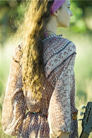 simsearch:633-01574151,k - Young hippie woman holding guitar, rear view Stock Photo - Premium Royalty-Free, Code: 633-01574176
