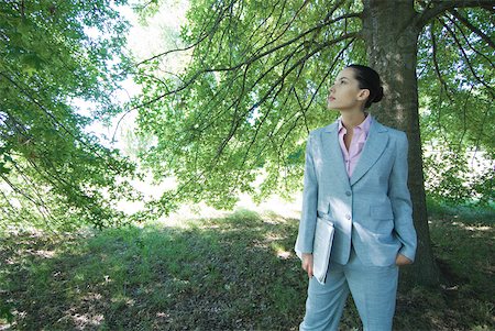 simsearch:633-01574151,k - Businesswoman standing in woods, looking up Stock Photo - Premium Royalty-Free, Code: 633-01574311