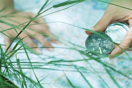 Person studying map and holding compass, cropped view of hands Stock Photo - Premium Royalty-Free, Code: 633-01574477