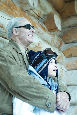 simsearch:695-03376367,k - Boy and grandfather standing near log cabin, looking away Stock Photo - Premium Royalty-Free, Code: 633-01574566