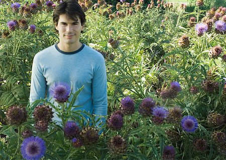 Man standing in flowers Stock Photo - Premium Royalty-Free, Code: 633-01572729