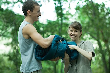 simsearch:633-01715612,k - Couple holding sleeping bag together Stock Photo - Premium Royalty-Free, Code: 633-01573769