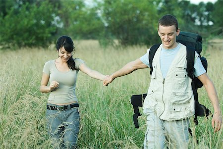 simsearch:633-01715612,k - Hiking couple walking through field Stock Photo - Premium Royalty-Free, Code: 633-01573788