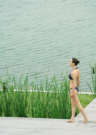 simsearch:633-01574151,k - Woman in swimsuit standing on deck, by body of water Stock Photo - Premium Royalty-Free, Code: 633-01573964