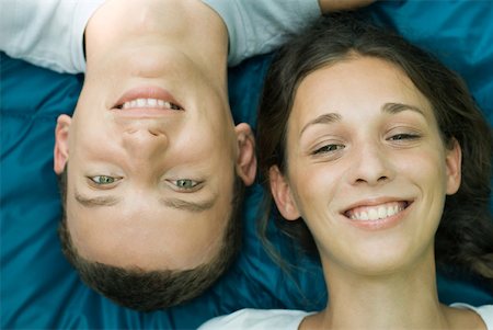 simsearch:633-01715612,k - Young couple smiling at camera, man upside down, close-up Stock Photo - Premium Royalty-Free, Code: 633-01714055