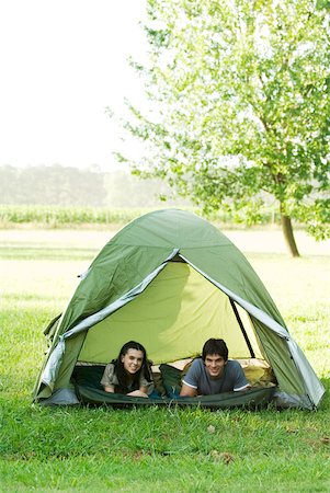 simsearch:633-01715612,k - Young campers lying down in tent, smiling at camera Stock Photo - Premium Royalty-Free, Code: 633-01714068