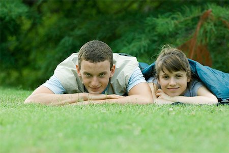 simsearch:633-01715612,k - Young campers in sleeping bags, smiling at camera Stock Photo - Premium Royalty-Free, Code: 633-01714060