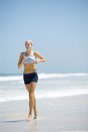 simsearch:633-01715682,k - Young woman jogging on beach Stock Photo - Premium Royalty-Free, Code: 633-01714379