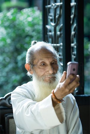 phone one person adult smile elderly - Elderly man wearing traditional Chinese clothing using camera phone Stock Photo - Premium Royalty-Free, Code: 633-01714718