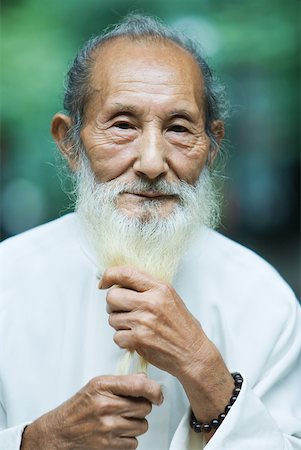 elderly humorous - Elderly man holding long white beard in hands, portrait Stock Photo - Premium Royalty-Free, Code: 633-01714735