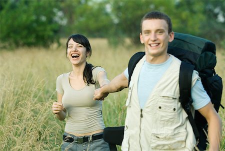 simsearch:633-01715612,k - Young couple going for hike, man pulling woman toward him Stock Photo - Premium Royalty-Free, Code: 633-01715629