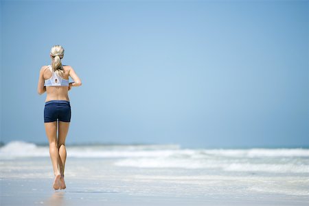 simsearch:633-01714467,k - Young woman running on beach, rear view Stock Photo - Premium Royalty-Free, Code: 633-01715652