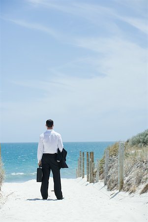 simsearch:632-03500607,k - Businessman standing on sandy path leading to ocean, rear view Stock Photo - Premium Royalty-Free, Code: 633-01713835