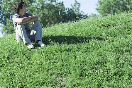 simsearch:633-01574151,k - Teen boy sitting on grassy hill, relaxing Stock Photo - Premium Royalty-Free, Code: 633-01713928