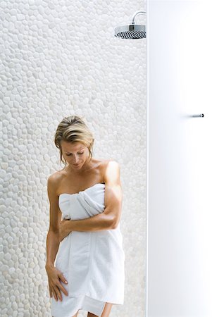 simsearch:696-03395895,k - Woman standing by shower, wrapped in towel, looking down Stock Photo - Premium Royalty-Free, Code: 633-01992498