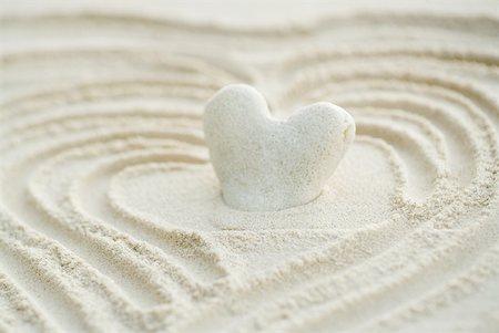 pebble - Heart shaped coral stuck in sand, close-up Stock Photo - Premium Royalty-Free, Code: 633-02065839