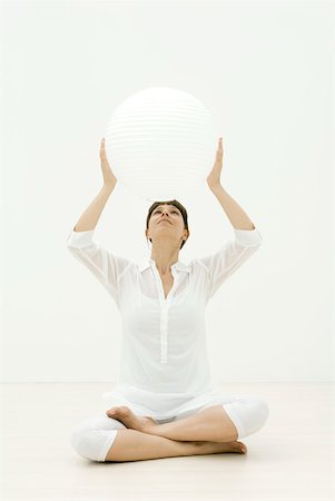 Woman holding up sphere Stock Photo - Premium Royalty-Free, Code: 633-02128698