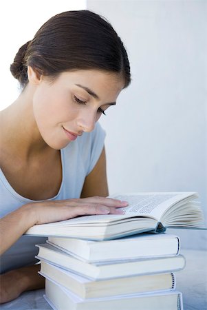 stalemate - Woman reading stack of books Stock Photo - Premium Royalty-Free, Code: 633-02345808