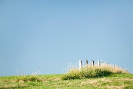 Fence ending in the middle of field Stock Photo - Premium Royalty-Free, Code: 633-02417657