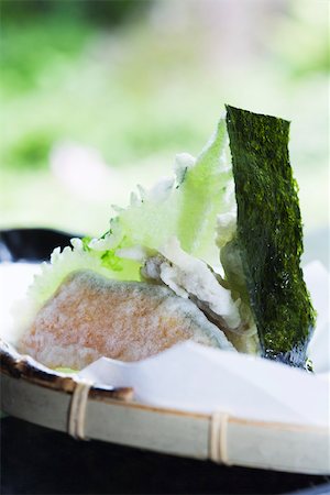 Winter squash and shiso tempura with piece of nori, close-up Stock Photo - Premium Royalty-Free, Code: 633-02417892