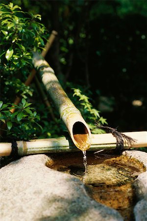 Water trickling from bamboo pipes into stone wash basin, Japan Stock Photo - Premium Royalty-Free, Code: 633-03194659