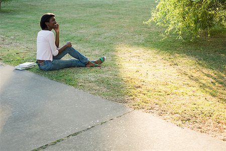 Young woman relaxing in park using cell phone Stock Photo - Premium Royalty-Free, Code: 633-03444560