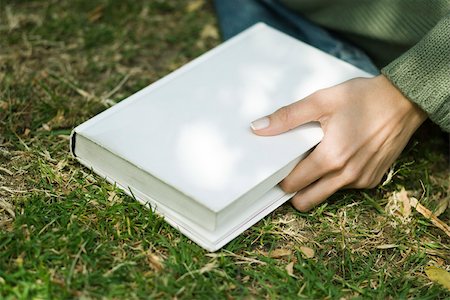 simsearch:632-03083700,k - Woman holding closed book, marking place with finger Stock Photo - Premium Royalty-Free, Code: 633-03444687