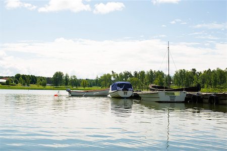 Boats docked near lake pier Stock Photo - Premium Royalty-Free, Code: 633-03444759