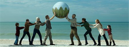 Ecology conceZS, group of people saving the earth together Stock Photo - Premium Royalty-Free, Code: 633-03445015