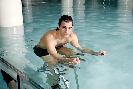 simsearch:644-01437057,k - Young man on exercise bike in spa pool Stock Photo - Premium Royalty-Free, Code: 644-01435728